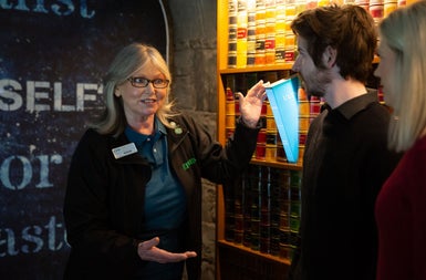 A guide speaking to two visitors