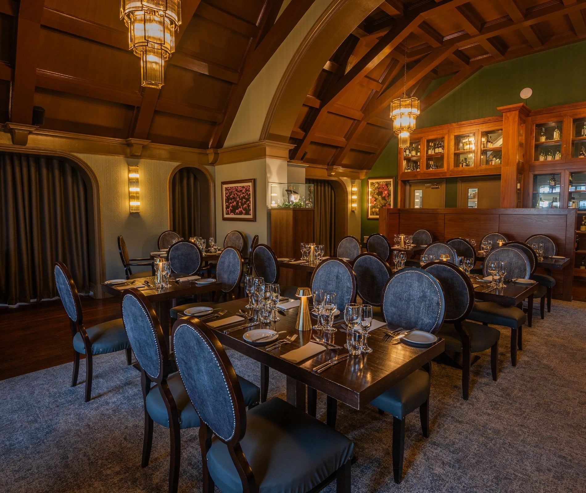 Restaurant with a domed shaped ceiling and chairs by tables set for service
