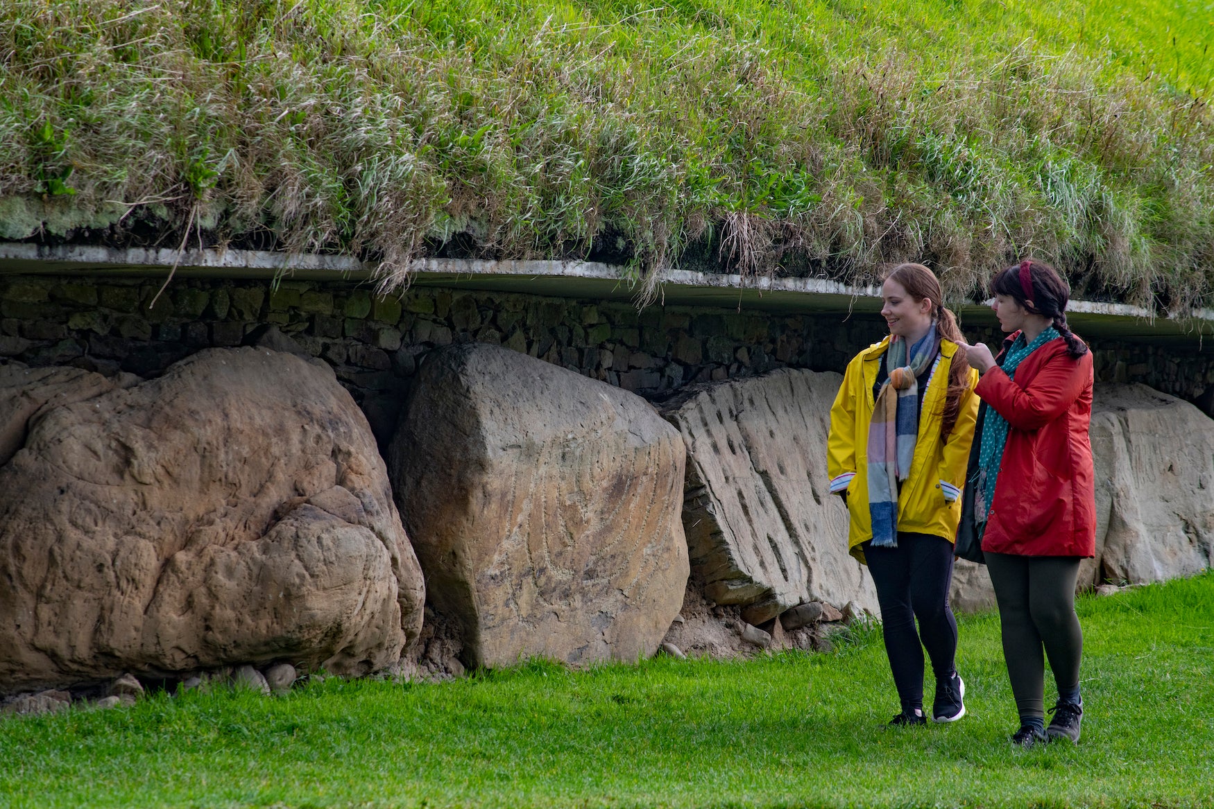 People looking at the kerbstones at Knowth, Co Meath