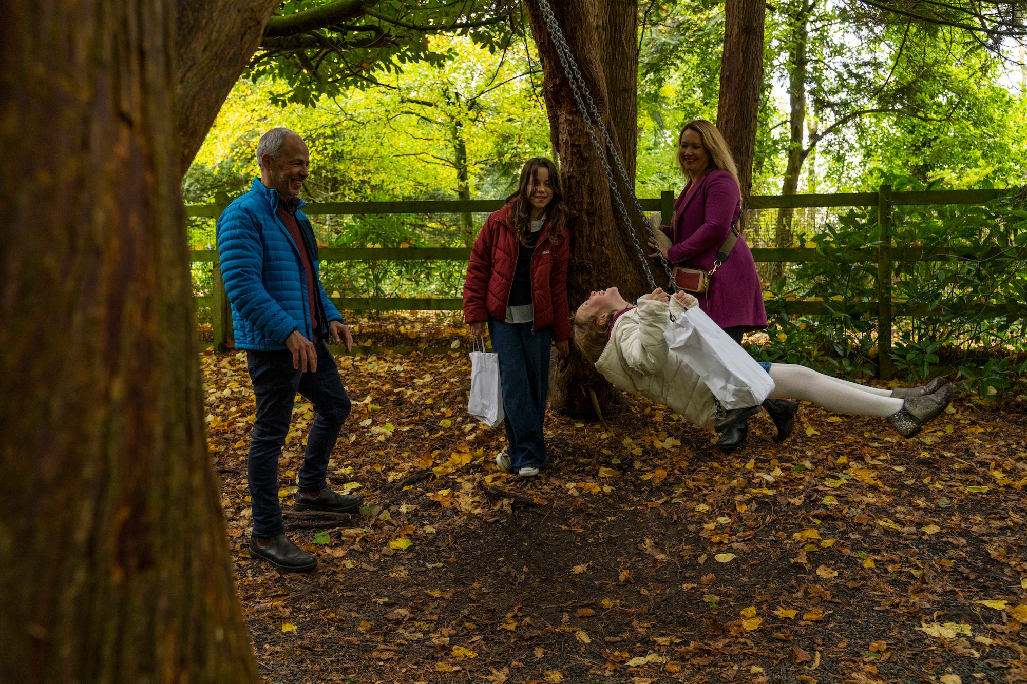 Child swinging in the woods at Belvedere House.