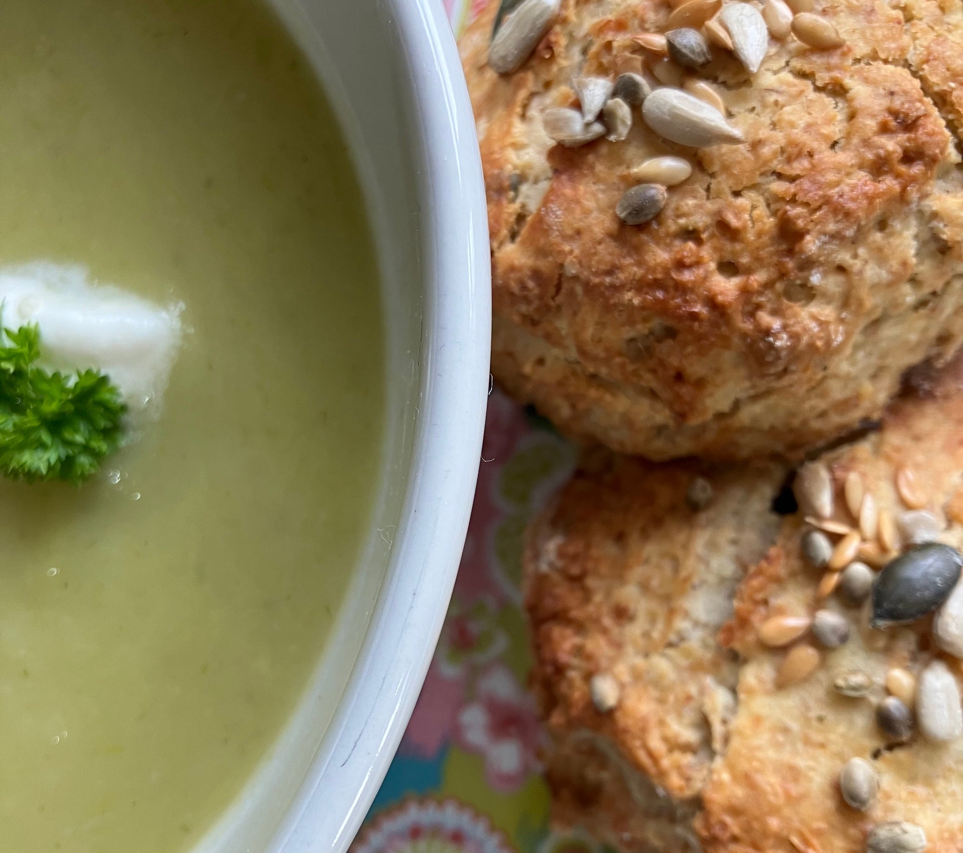 Close up view of a bowl of soup and scones