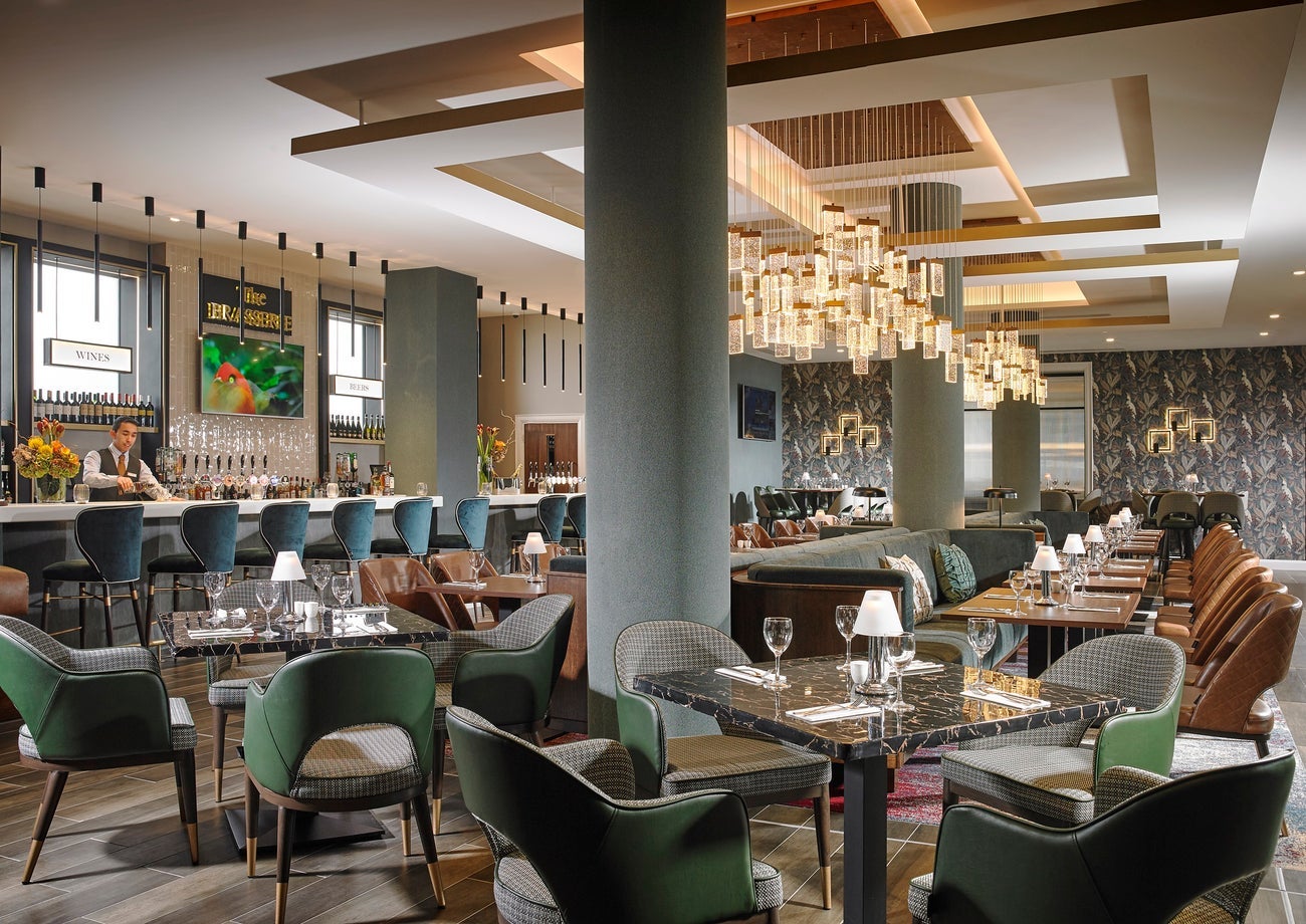 An empty restaurant and bar with dining tables prepared for diners