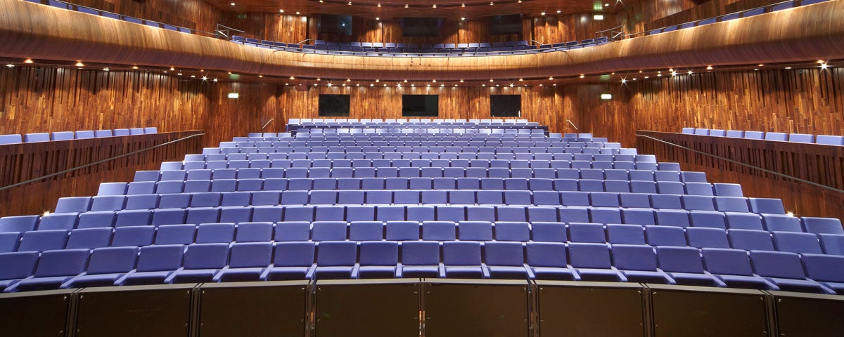 A view from a stage onto an empty seating area surrounded by a balcony
