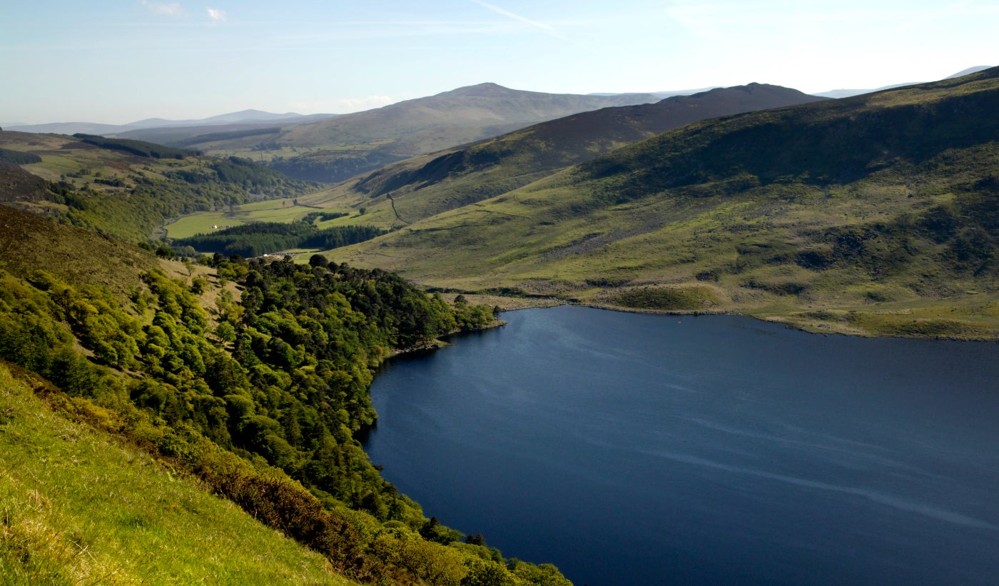 Blue lake set in the middle of rolling green hills in the Wicklow Mountains, Wicklow.