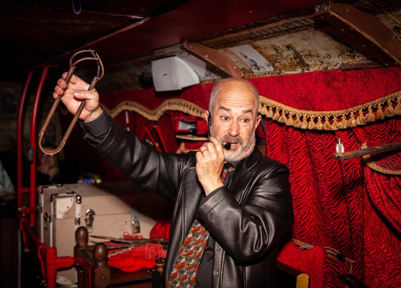 A bus tour guide giving a ghost tour on a bus