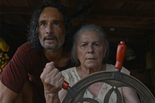 A worried looking older man and woman looking ahead.