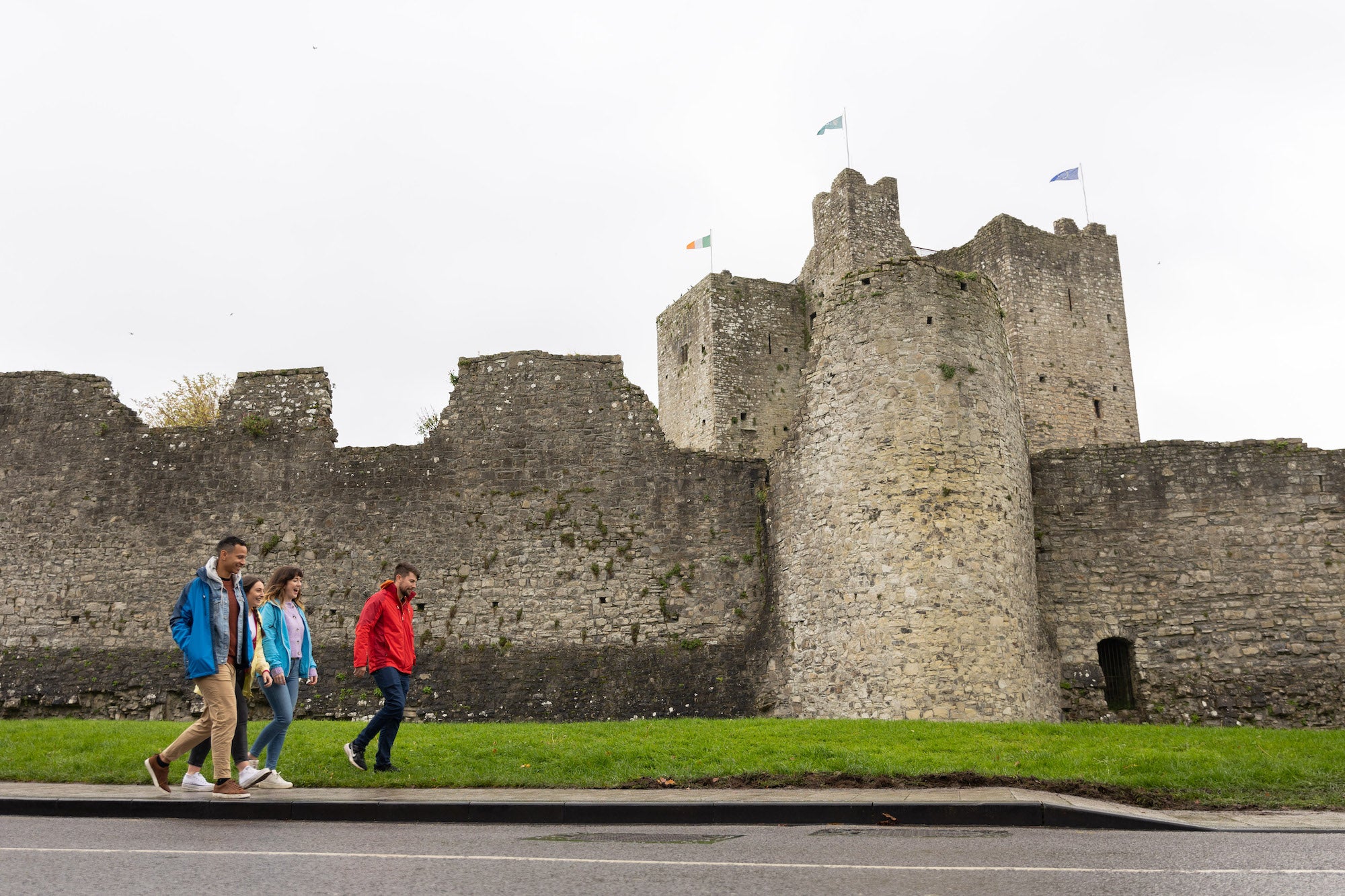 People walking past Trim Castle, Co Meath