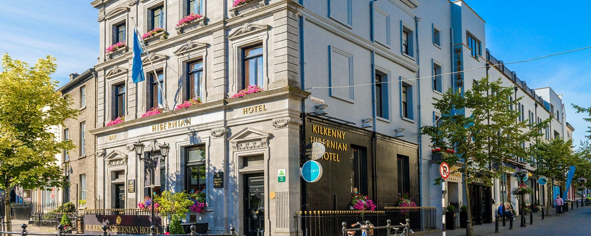 A view of the external of the Kilkenny Hibernian Hotel in Kilkenny City with a blue sky in the background