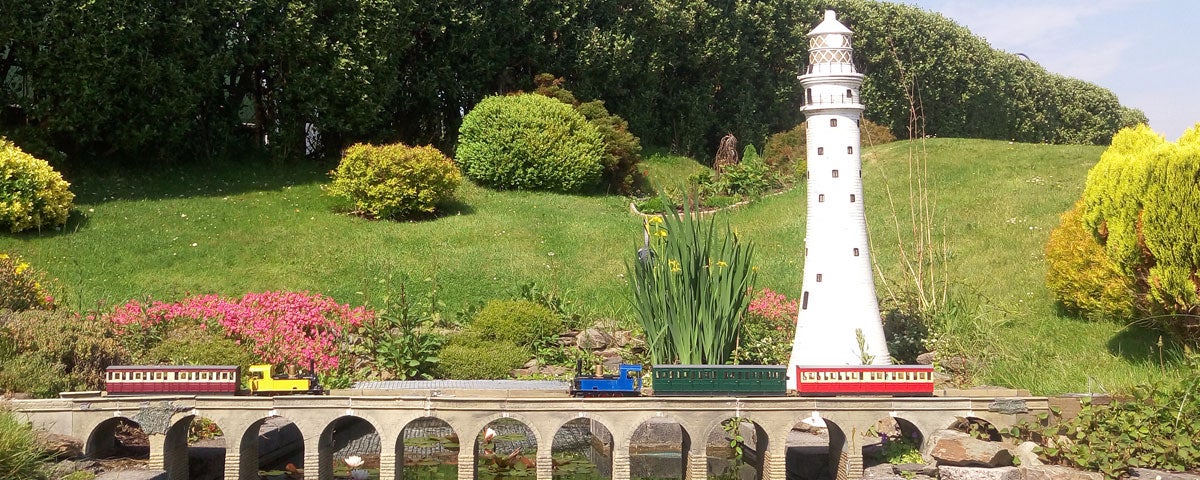 Miniature train going over a miniature railway viaduct at West Cork Model Railway Villiage
