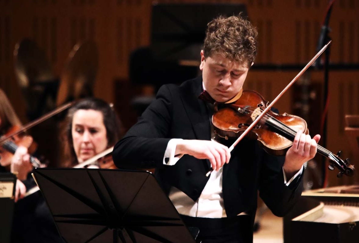 Patrick Rafter playing the violin in concert attire.