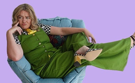 A person looking confused is laying across a soft chair.