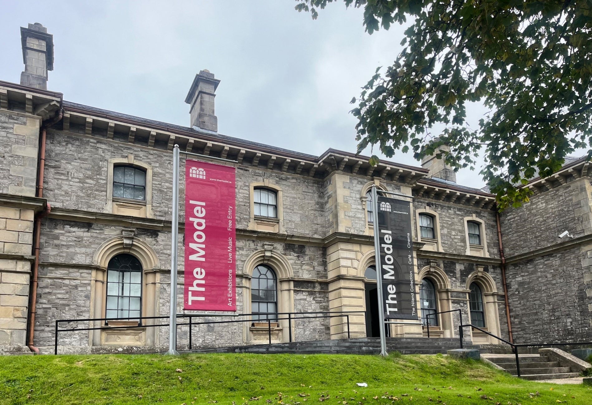 Stone exterior of a gallery building with steps leading up to it