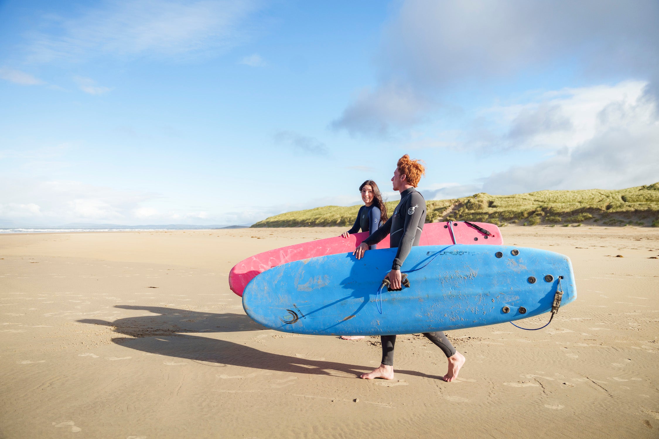 Two surfers on Tullan Strand in Co Donegal