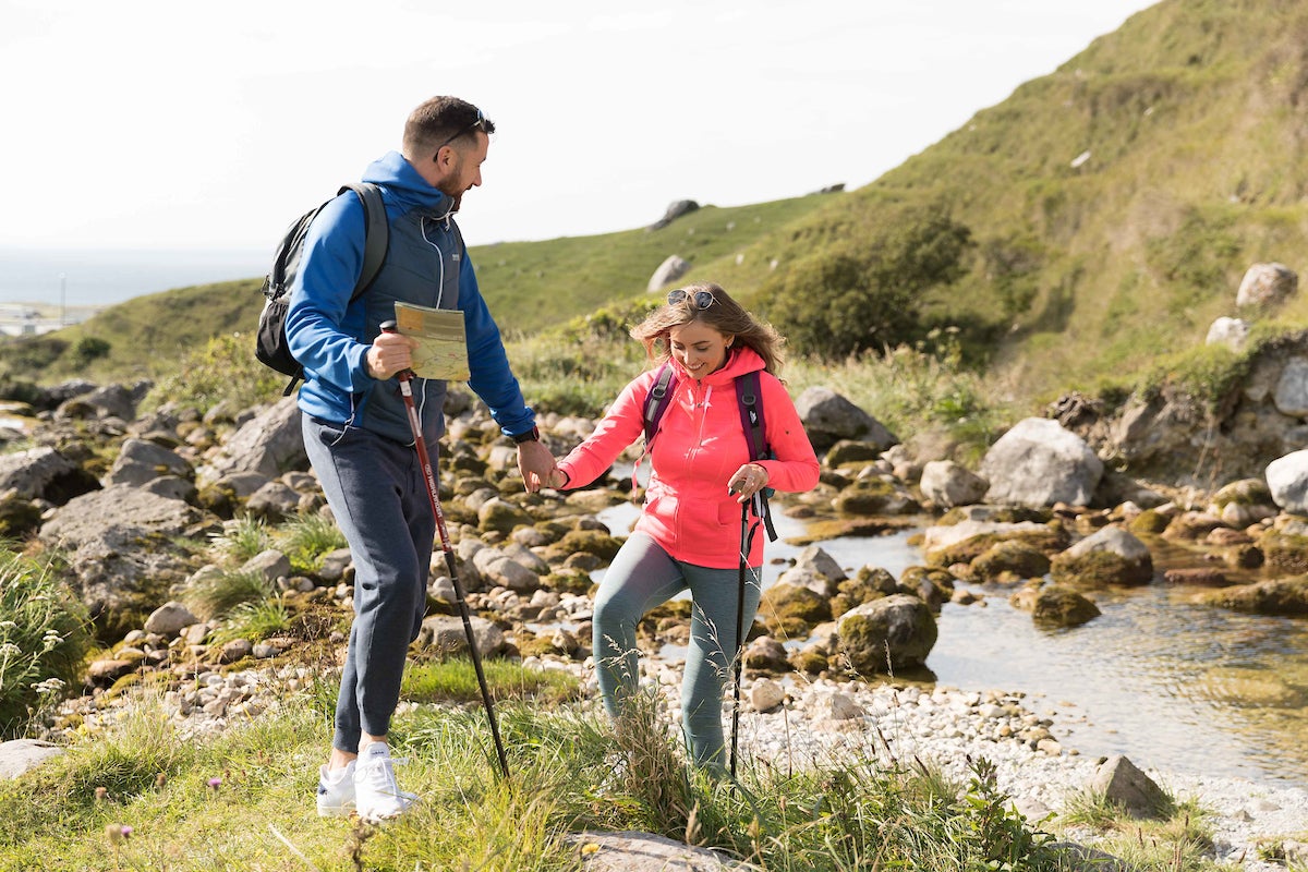 A couple hiking the Caher Valley Loop in Fanore, County Clare.