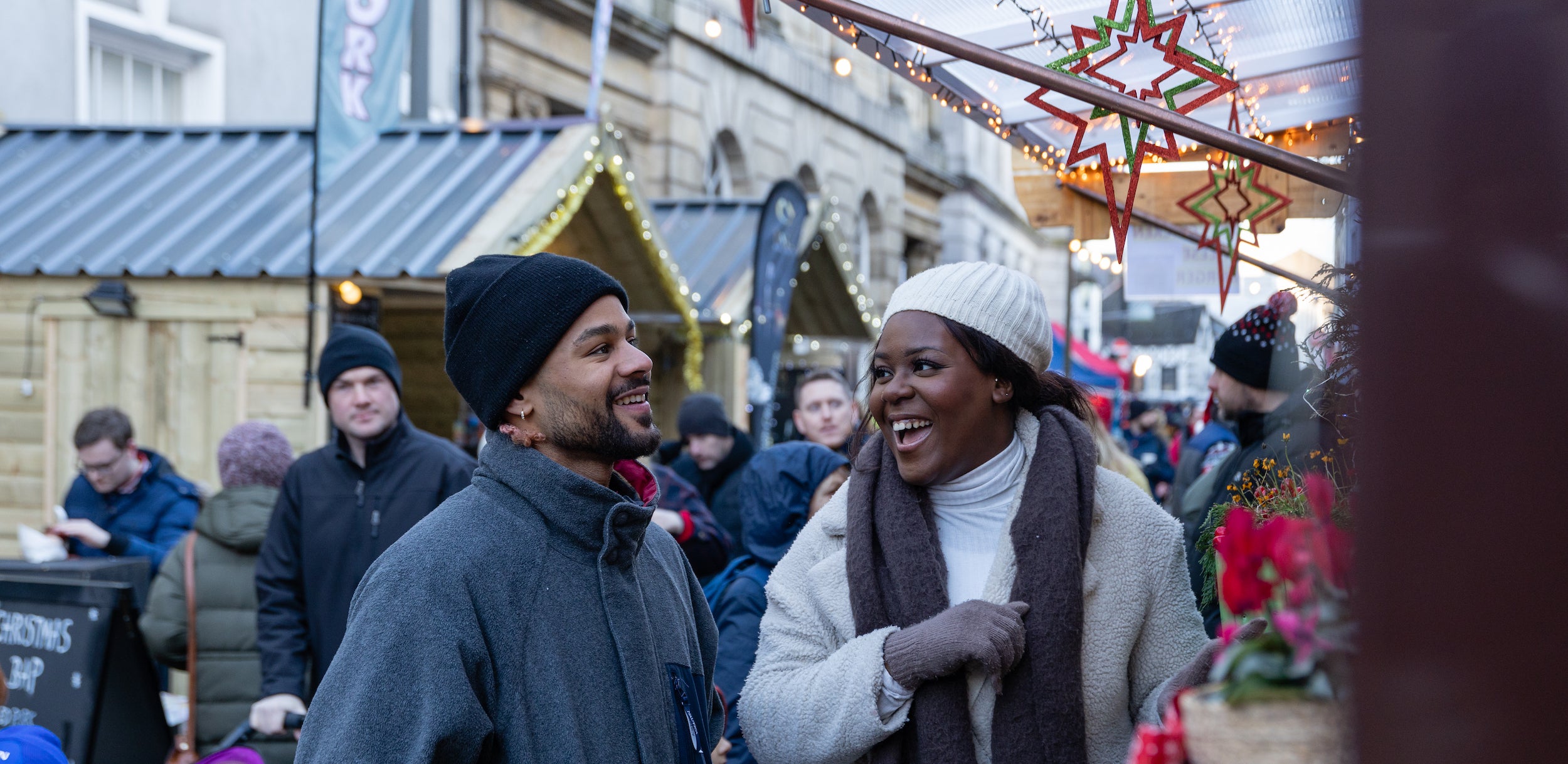 Couple laughing outside a chalet at Winterval.