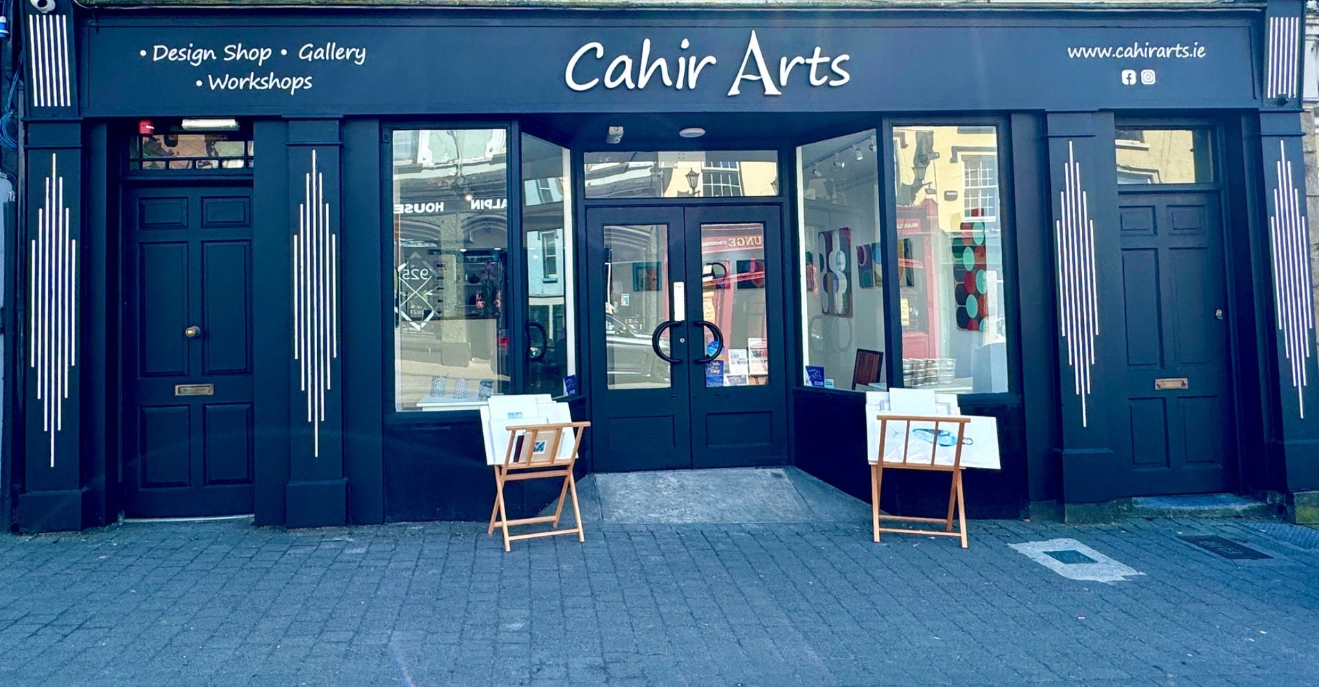 Art gallery exterior with small easels on display at the door