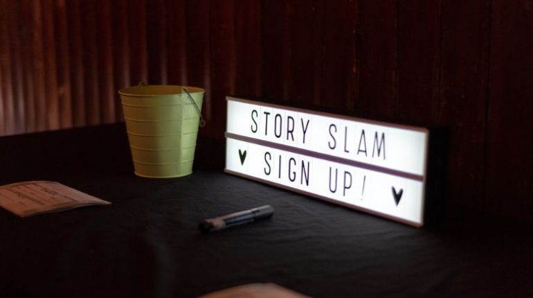 A rectangular light box with slim black writing on white background.