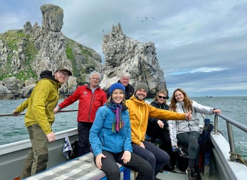 A group of passengers on a tour boat at sea