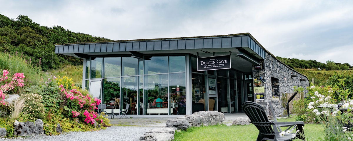A view of the Doolin Cave Visitor Centre from their garden with colourful flowers