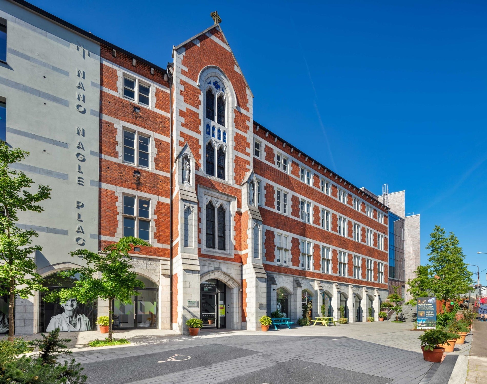 Exterior of red brick former convent building with some trees nearby