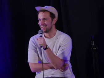 A comedian with a microphone in his hand