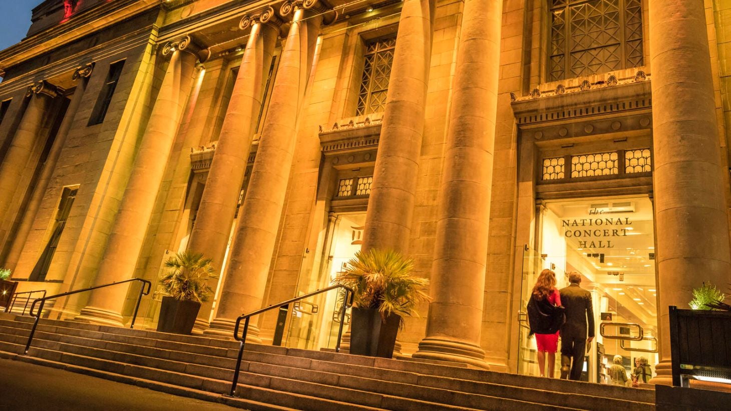 Two people entering the National Concert Hall.
