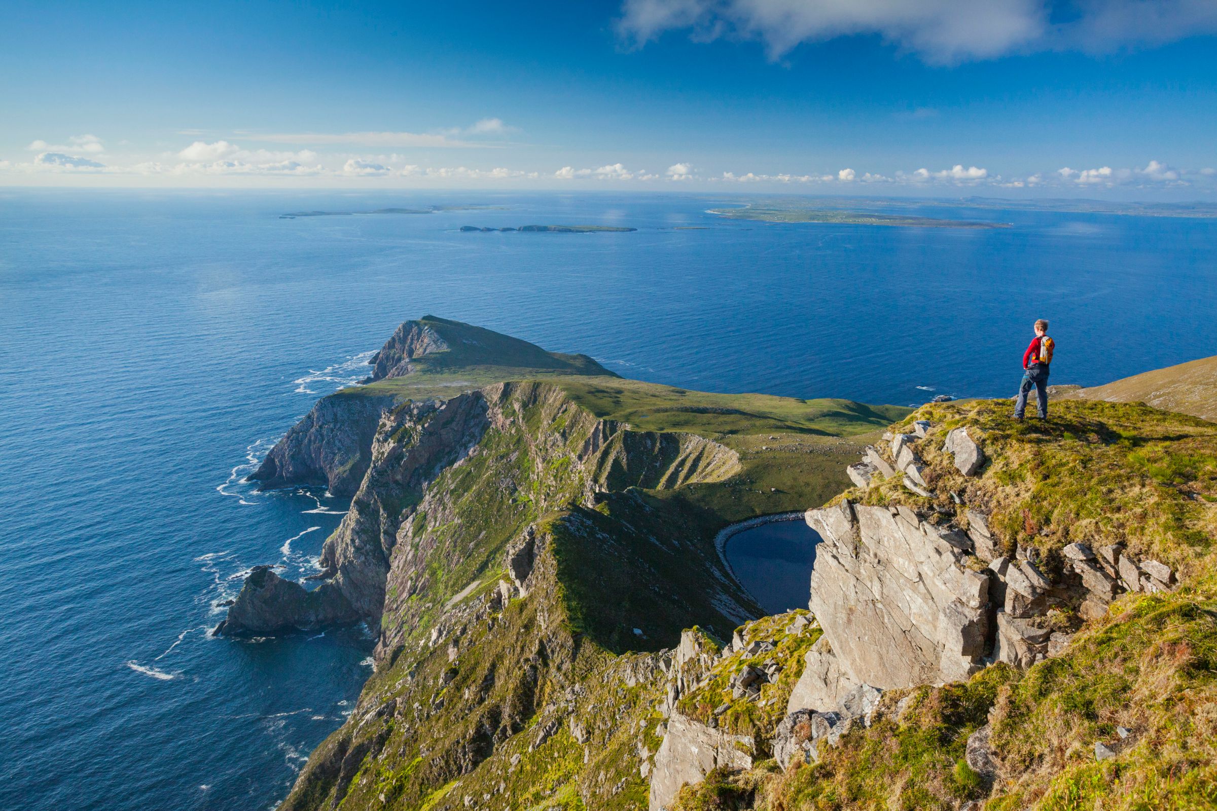 Person standing on a clifftop looking at Croaghaun, Achill Island, Co Mayo