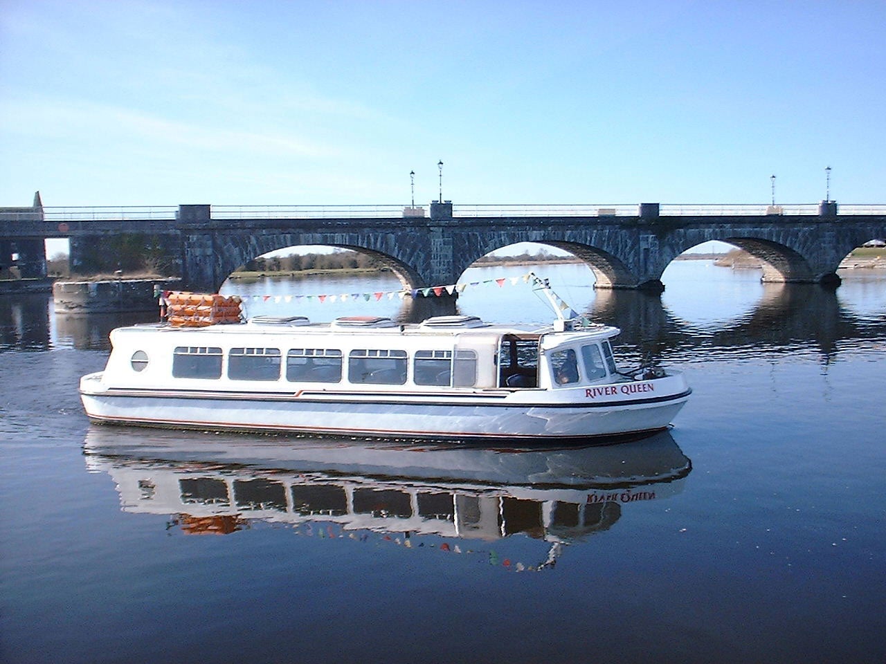 Silver Line Cruisers river queen boat on the water near a bridge