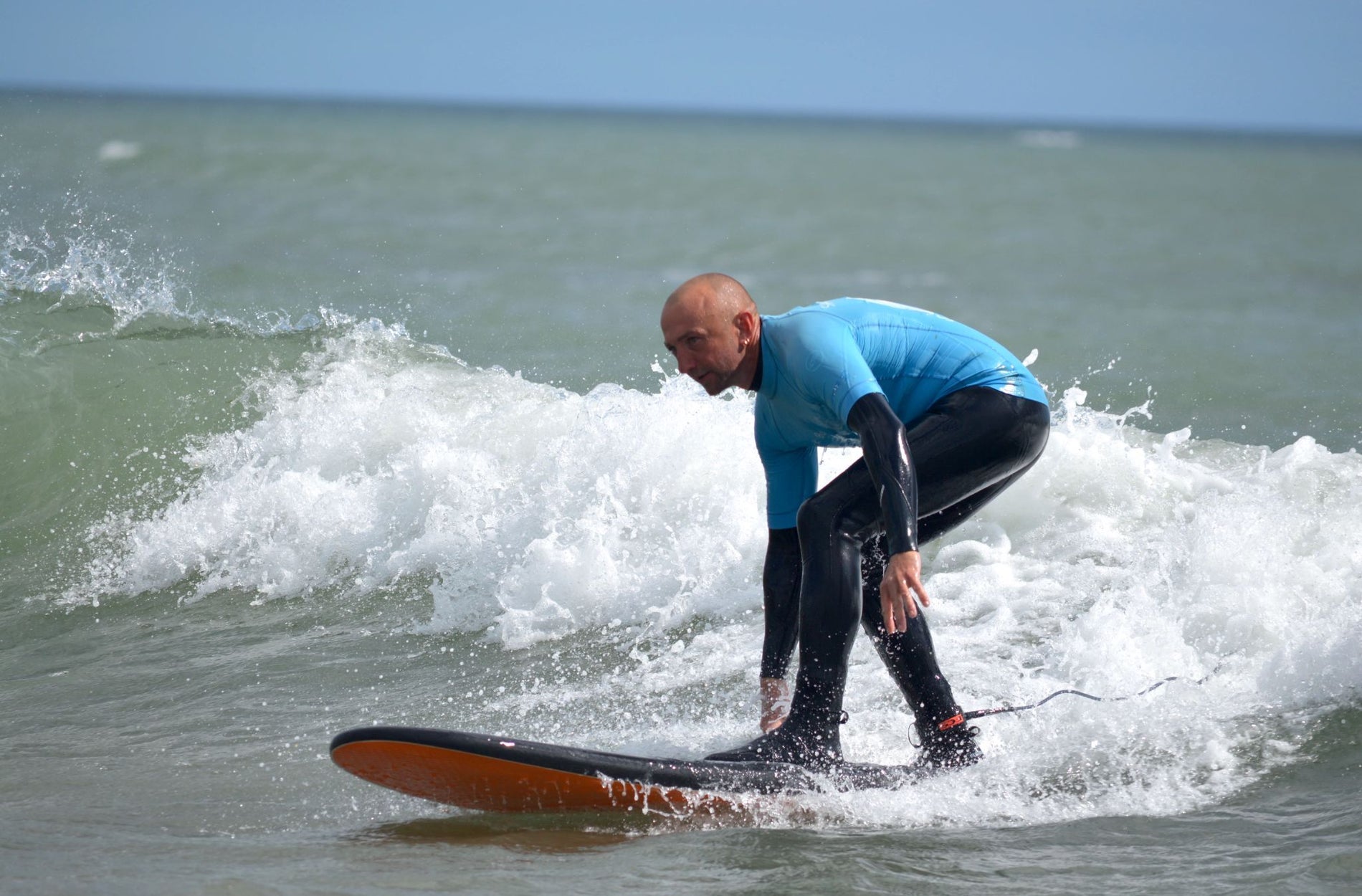 A close up of a man on a surf board
