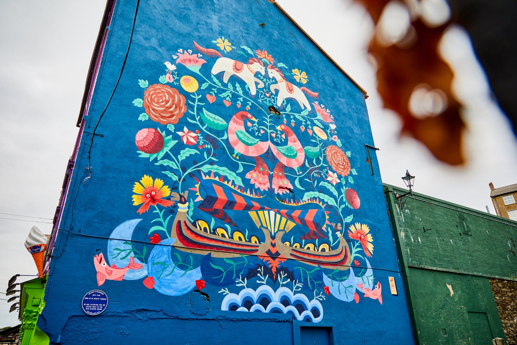Floral street art on the side of a building in New Ross.