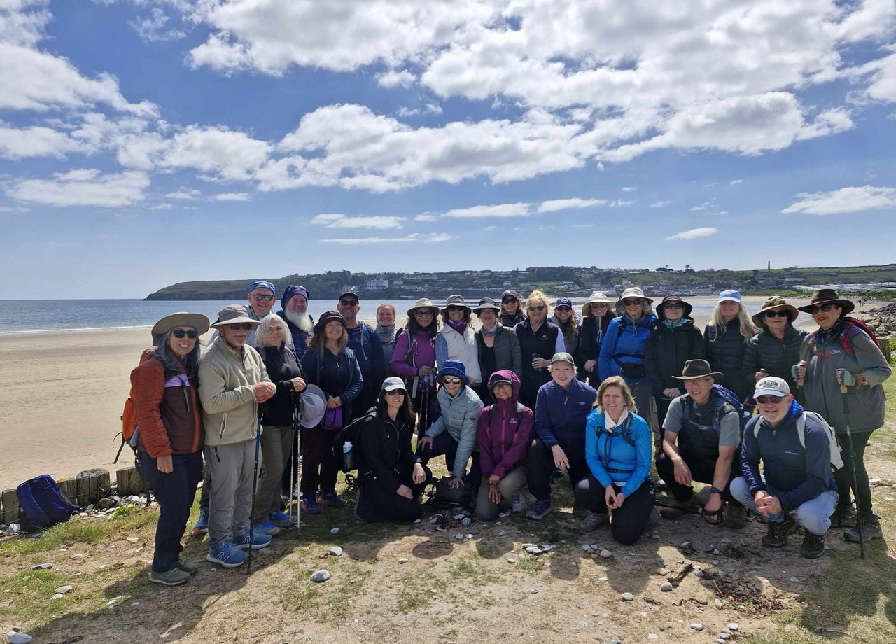 A group of people posing for a photo on a beach