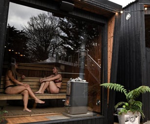 Two girls sitting inside a sauna at The Hot Box Sauna Inchicore