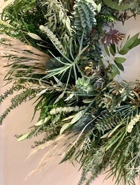 Part view of green foliage as part of a wreath.