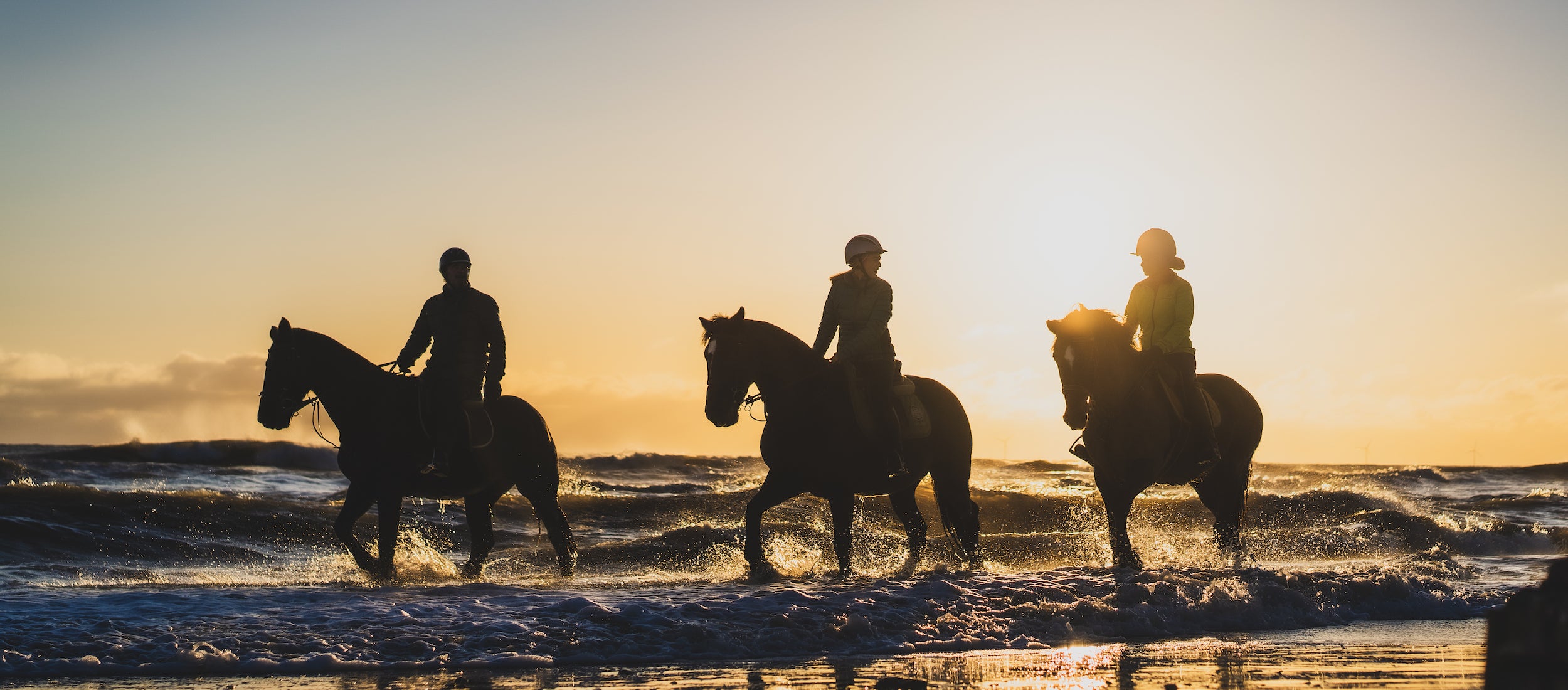 Three horse riders at Brittas Bay in County Wicklow