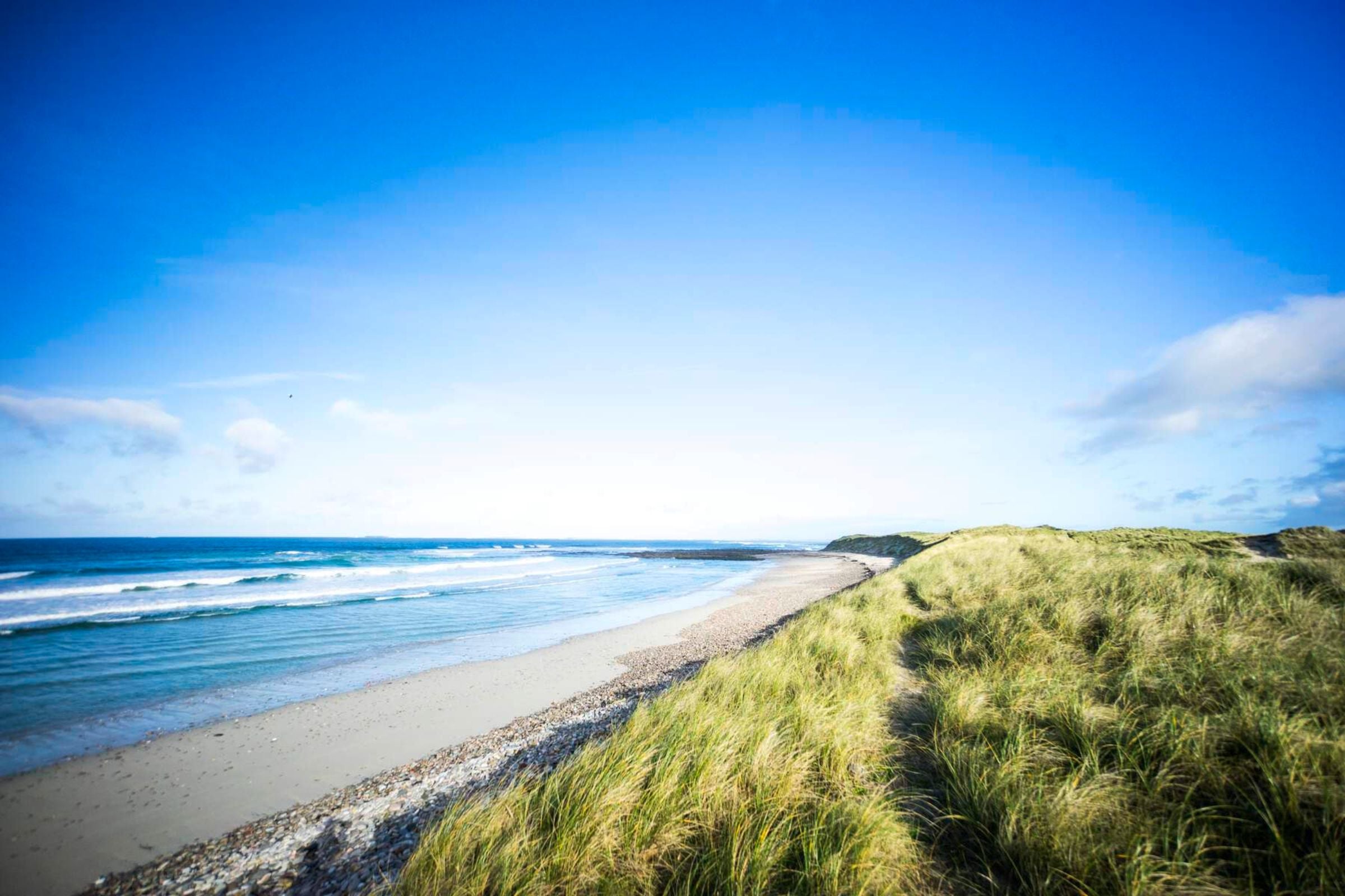 Blue skies meet the Atlantic Ocean at Elly Beach in Belmullet, County Mayo.