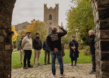 Group on a walking tour stopped listening to the guide of the tour