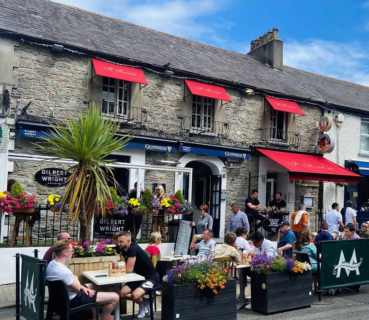 People sitting in a dining area outside a pub