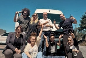 Film - Palestine Comedy Club, a group of 7 people at the front of a white van on a sunny day.