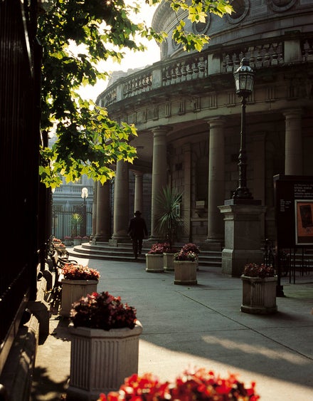 An exterior image of a person walking into the National Museum of Ireland - Archaeology building