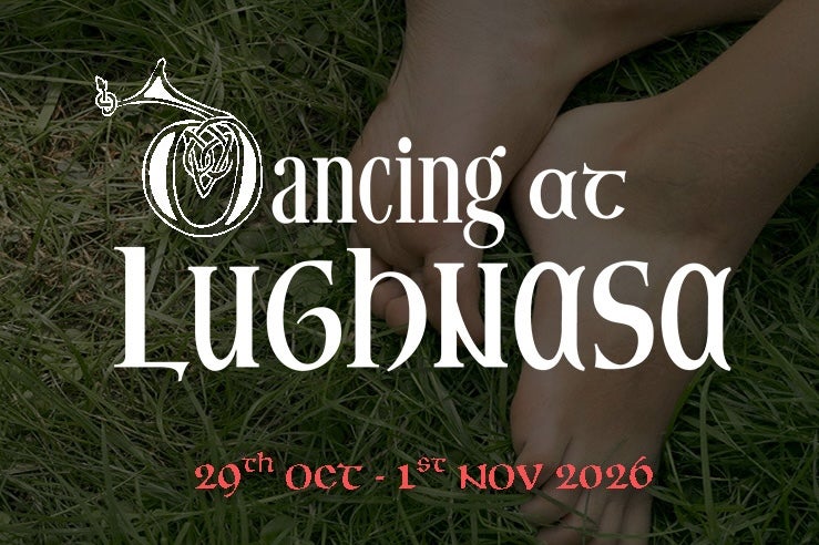Feet in the grass with the title of the play in white writing