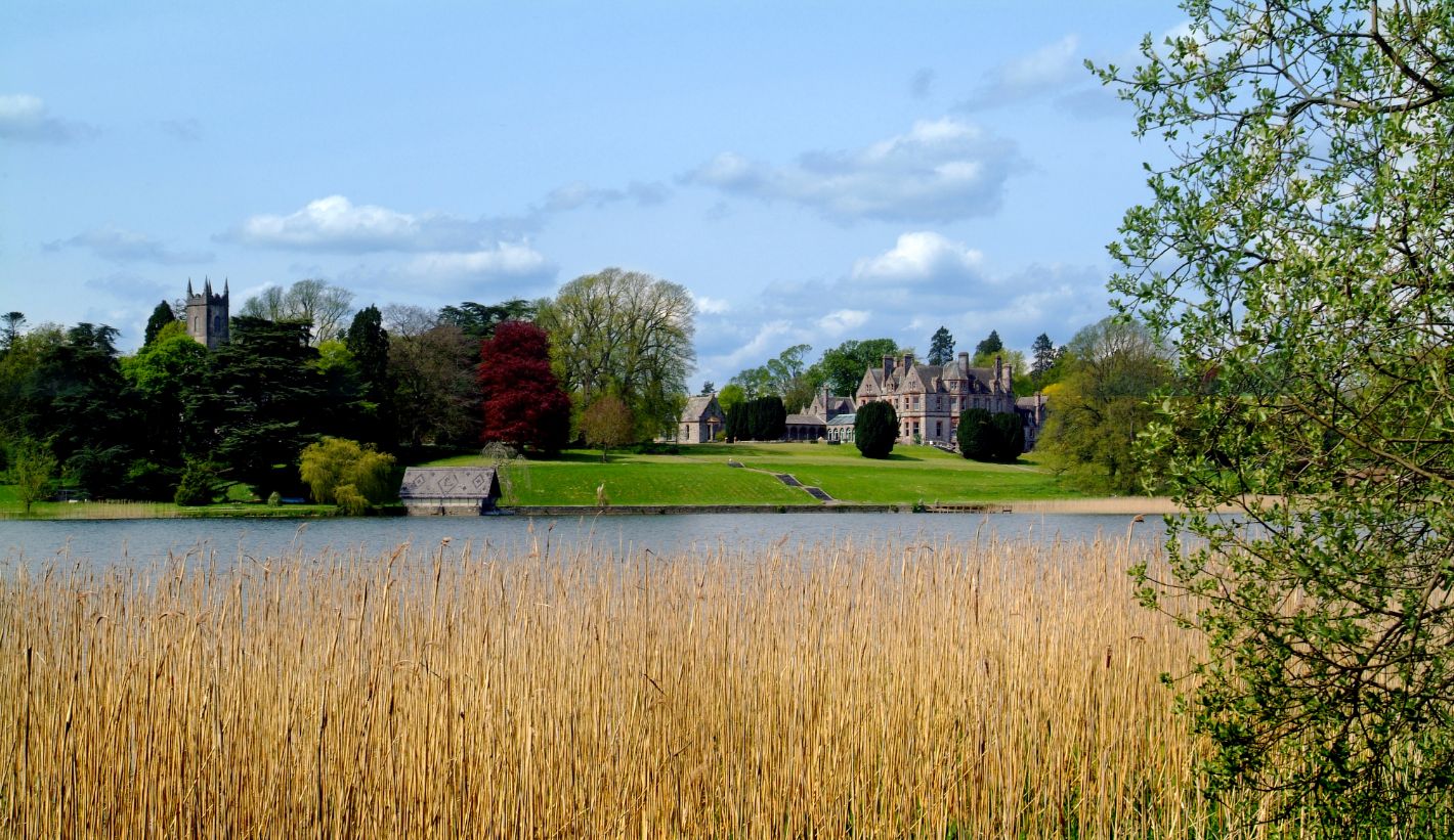 Green grass and blue water in front of Castle Leslie Estate, Monaghan