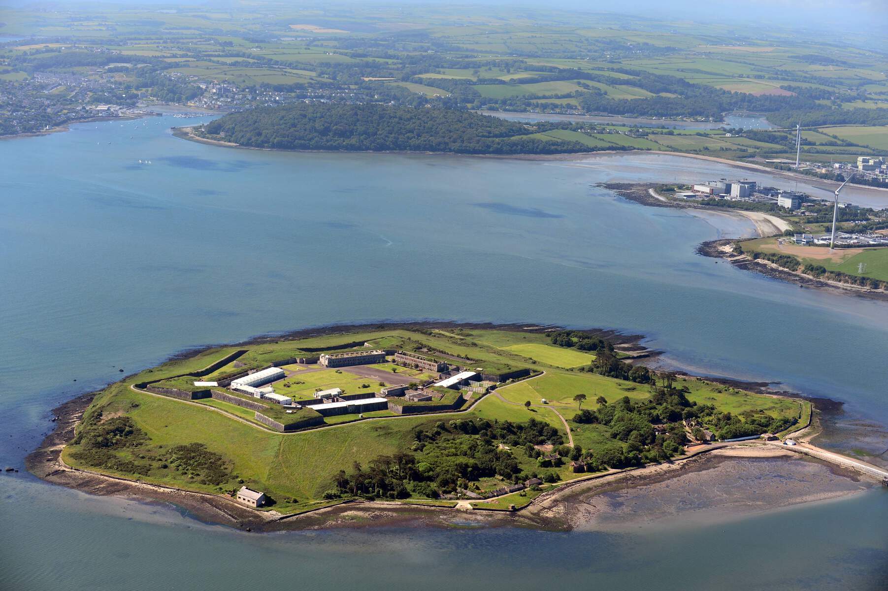 Island from the air with the sea around it and mainland in the background
