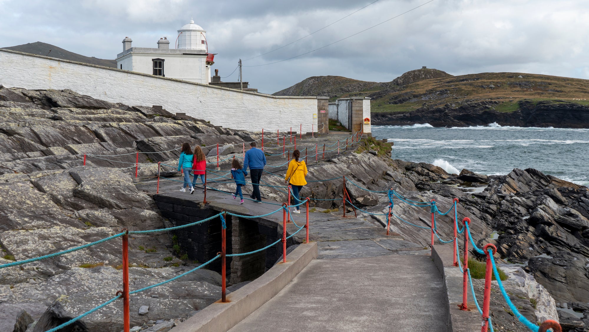A family walking to Valentia Lighthouse in Valentia Island, Co Kerry