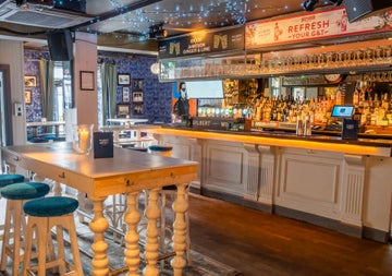 Wooden high table and bar in a pub