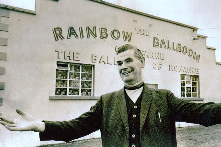 Rainbow Ballroom of Romance exterior and host in a black and white photo