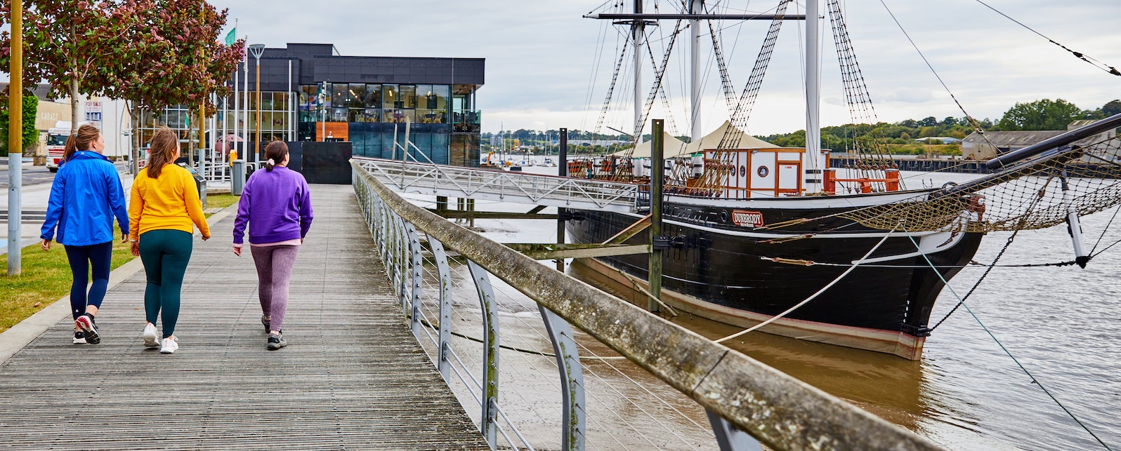 Three people walking to the Dunbrody Famine Ship Experience in County Wexford.