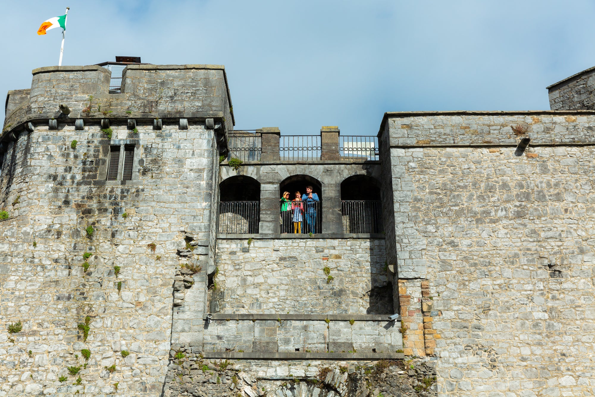 A family standing on the balcony of King John's Castle in Limerick.
