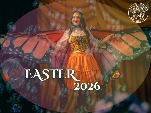 Picture of children's entertainer dressed as a butterfly, surrounded by bubbles