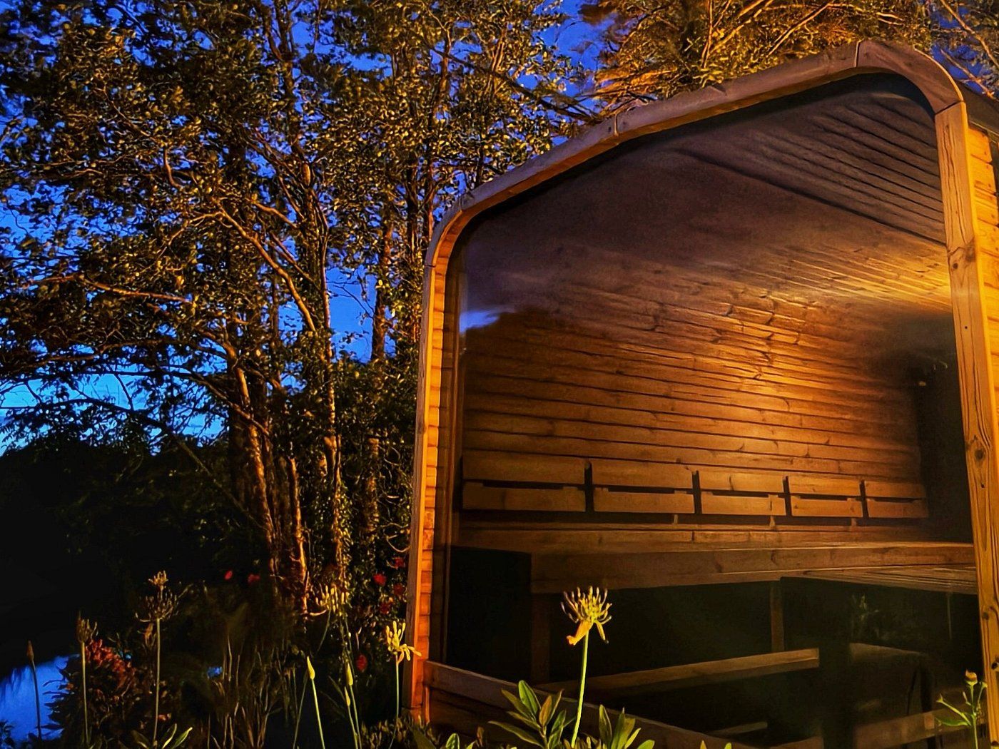 A lakeside sauna by night