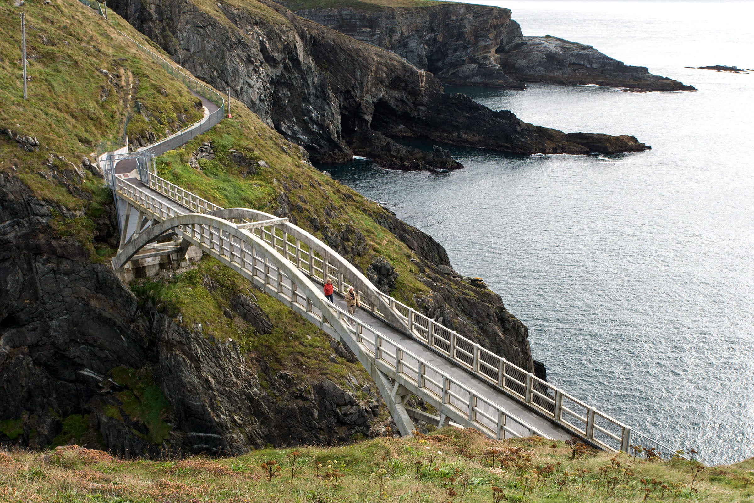 People walking across the bridge at Mizen Head in County Cork.